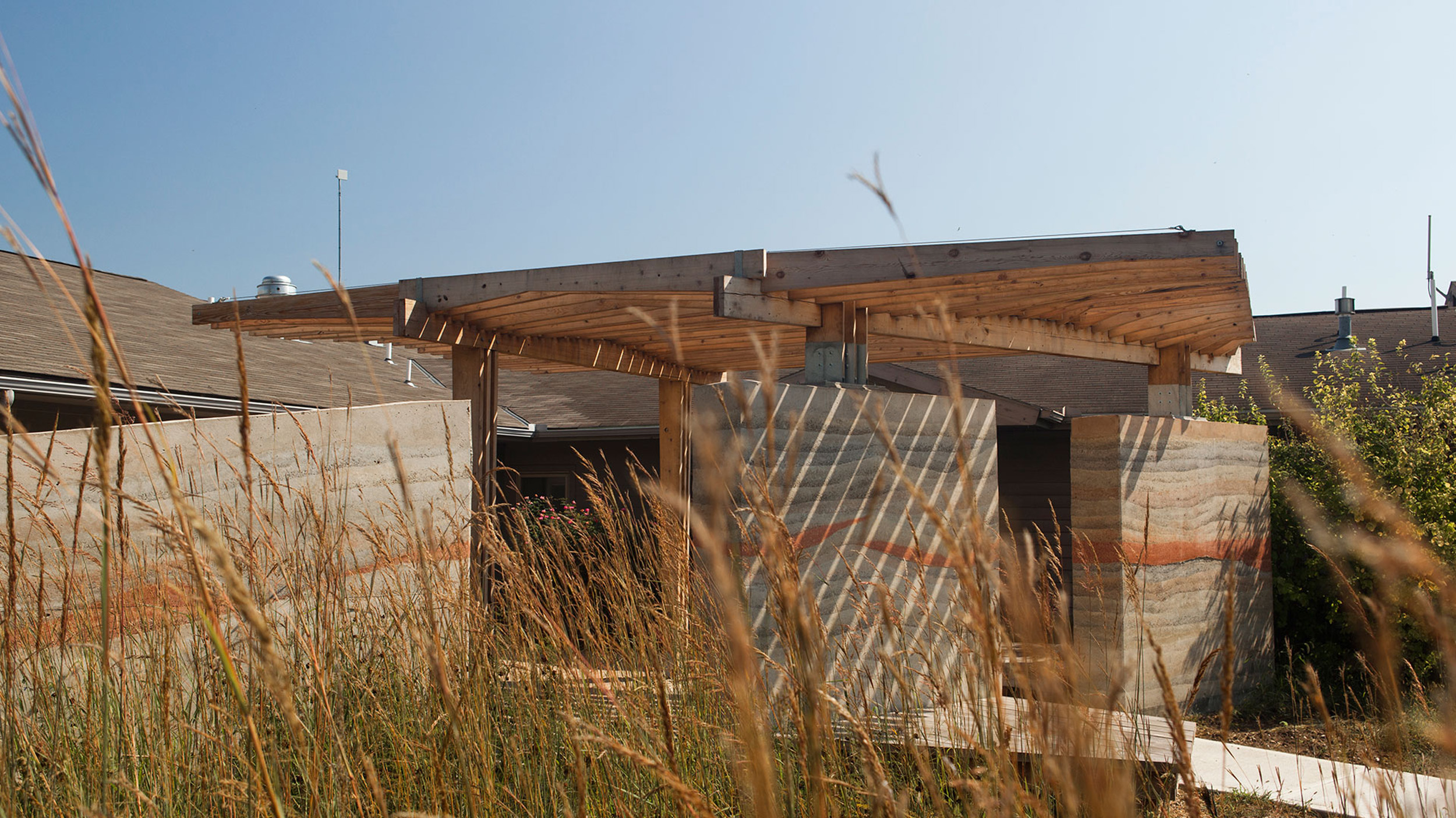 Armitage Pavilion, a series of rammed earth walls supporting a timber sunshade