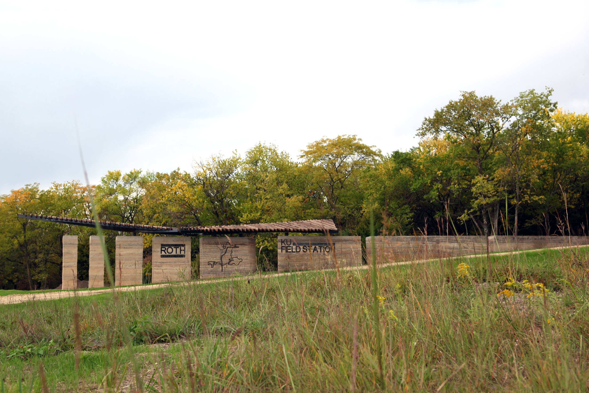 Roth Trailhead, a rammed earth wall registers the vastness of the prairie