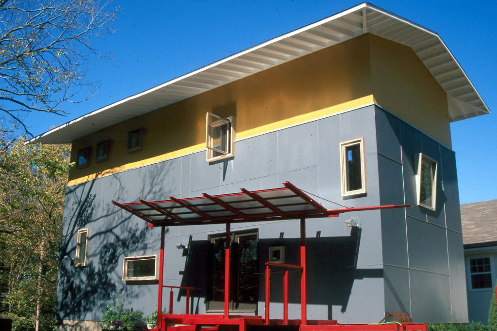 modern house with red, yellow, and gray facade