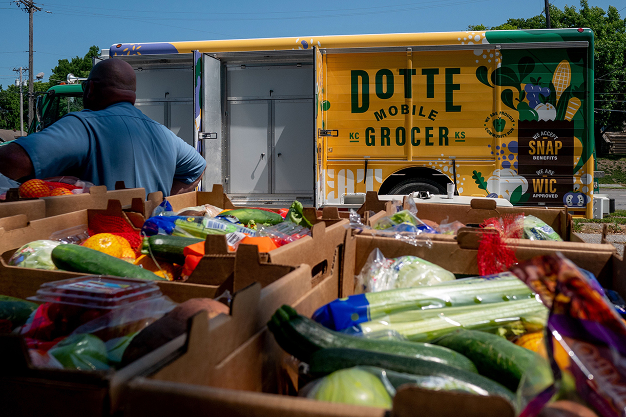 image of grocery truck with vegetables in foreground