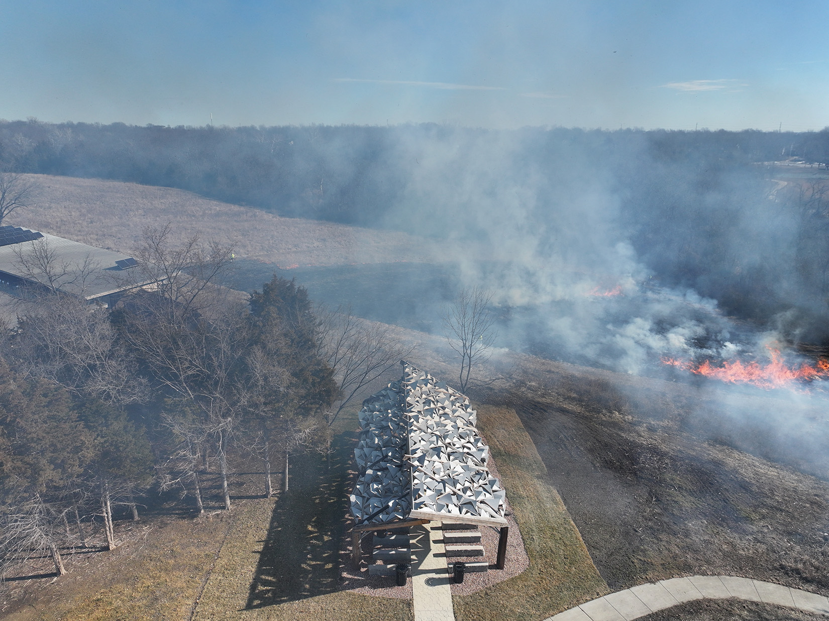 Smoke and fire surrounding a park pavilion