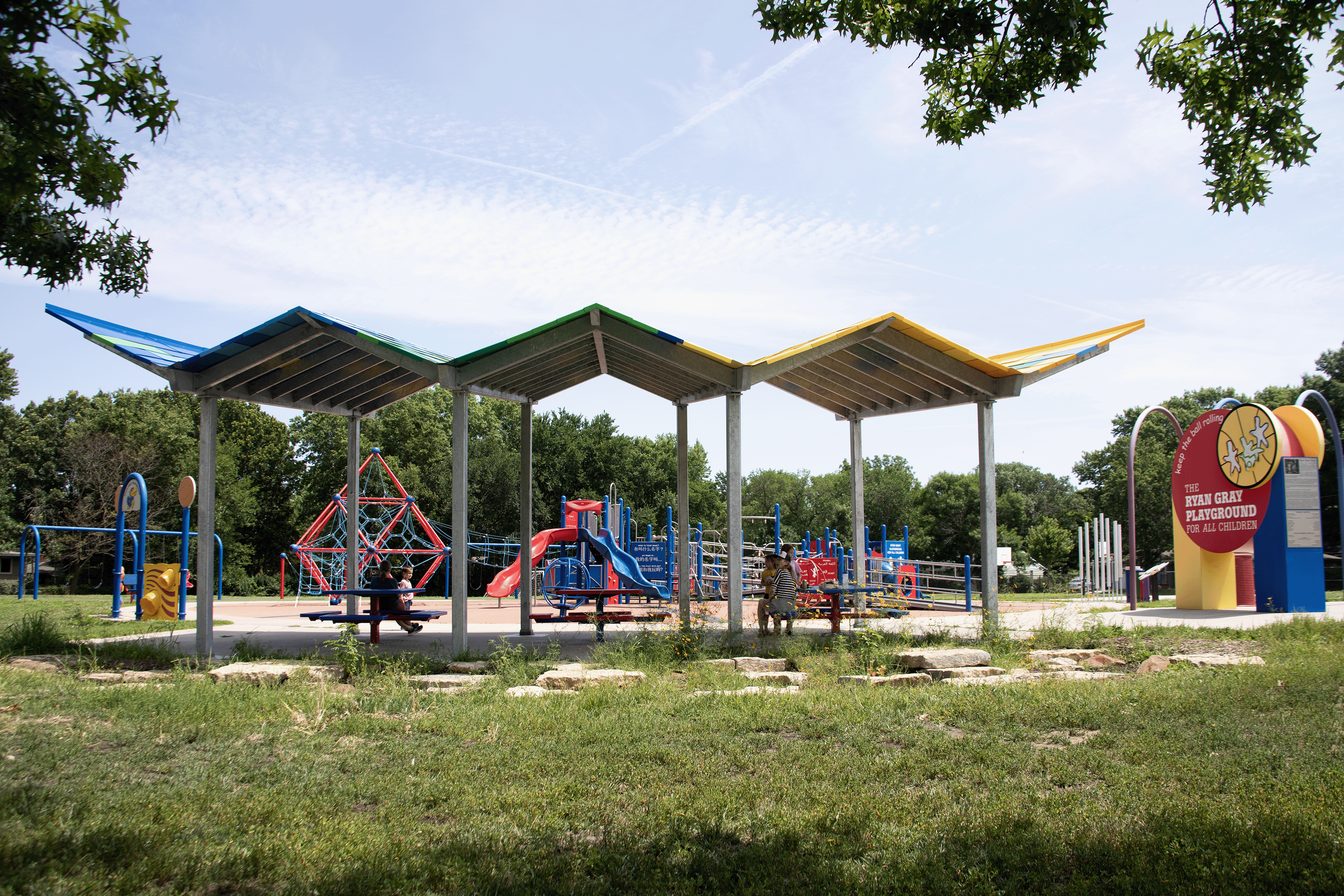 Architectural pavilion with playground behind it
