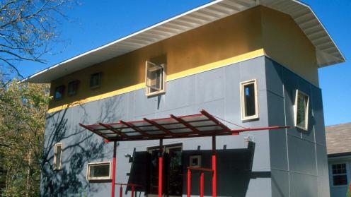 modern house with red, yellow, and gray facade