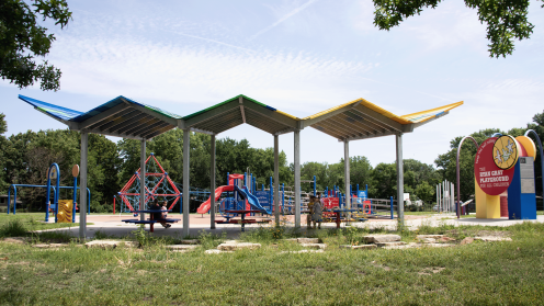 Architectural pavilion with playground behind it